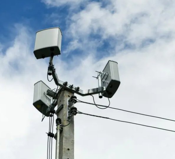 Small cell antennas mounted on a utility pole against a cloudy sky